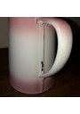 Old coffee maker in pink and white enamelled sheet metal