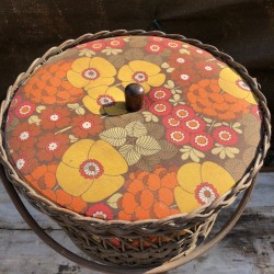 Old small vintage worker in rattan and floral fabric