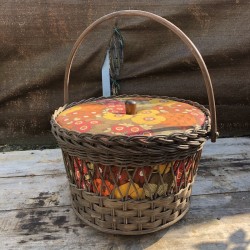 Old small vintage worker in rattan and floral fabric