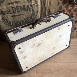 Old wooden and sheepskin suitcase with metal reinforcements