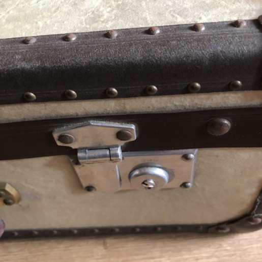 Old wooden and sheepskin suitcase with metal reinforcements