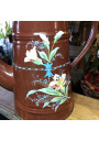 Old coffee maker in brown enamelled sheet metal with embossed floral decoration