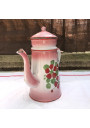 Old coffee maker in pink and white enamelled sheet metal with floral decoration