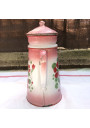 Old coffee maker in pink and white enamelled sheet metal with floral decoration