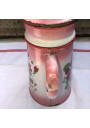 Old coffee maker in pink and white enamelled sheet metal with floral decoration