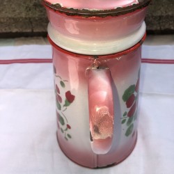 Old coffee maker in pink and white enamelled sheet metal with floral decoration