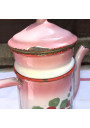 Old coffee maker in pink and white enamelled sheet metal with floral decoration