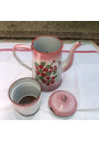 Old coffee maker in pink and white enamelled sheet metal with floral decoration