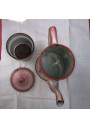 Old coffee maker in pink and white enamelled sheet metal with floral decoration