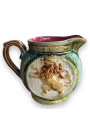Old small pitcher in dabbling lion decor