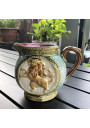 Old small pitcher in dabbling lion decor