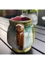 Old small pitcher in dabbling lion decor