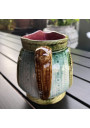 Old small pitcher in dabbling lion decor
