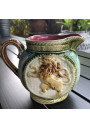 Old small pitcher in dabbling lion decor