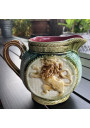 Old small pitcher in dabbling lion decor