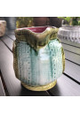 Old small pitcher in dabbling lion decor