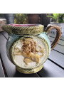 Old small pitcher in dabbling lion decor