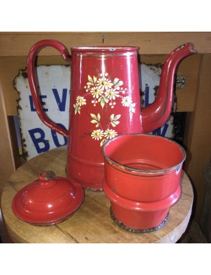 Old coffee maker in red enamelled sheet metal with embossed floral decoration
