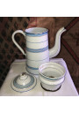 Old coffee maker in enameled sheet metal with blue and gold stripes
