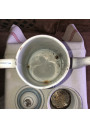 Old coffee maker in enameled sheet metal with blue and gold stripes
