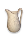 Old small milk jug in ivory-colored art nouveau style biscuit