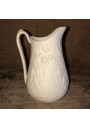 Old small milk jug in ivory-colored art nouveau style biscuit