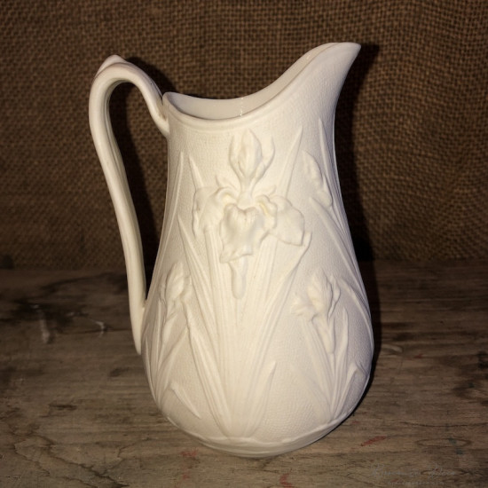 Old small milk jug in ivory-colored art nouveau style biscuit