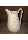 Old small milk jug in ivory-colored art nouveau style biscuit