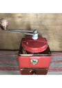 Old red Peugeot Frères coffee grinder in metal and wood