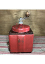 Old red Peugeot Frères coffee grinder in metal and wood