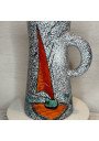 Old pitcher with black and white granite decoration and sailboat