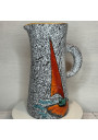 Old pitcher with black and white granite decoration and sailboat