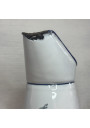 Old enamelled sheet metal pitcher with blue floral decoration on a white background