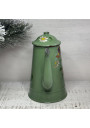 Old coffee pot in green enameled sheet metal with floral decoration in relief