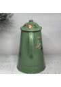 Old coffee pot in green enameled sheet metal with floral decoration in relief