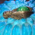 Antique cicada brooch with green stone cabochon
