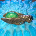 Antique cicada brooch with green stone cabochon